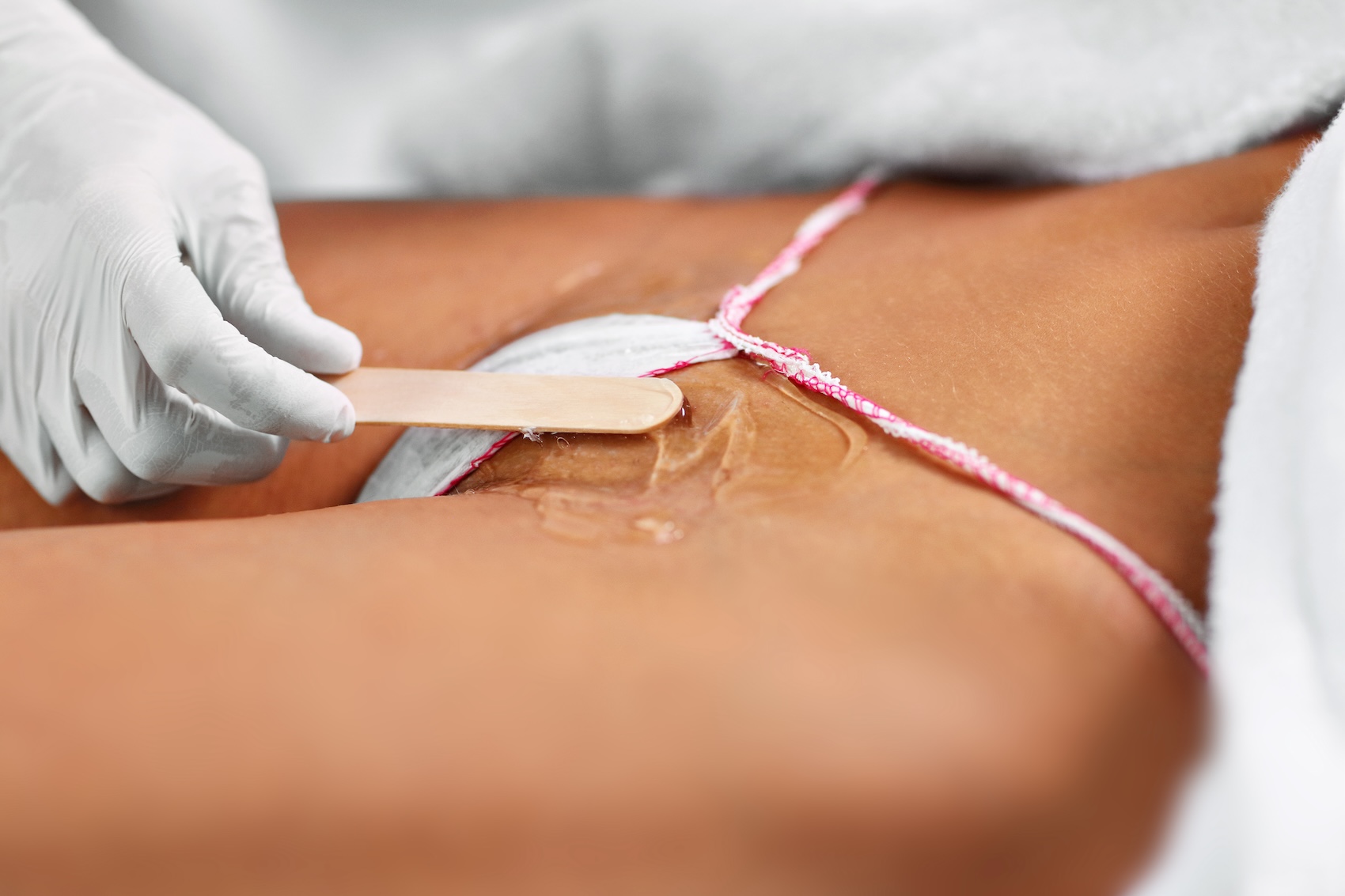 An aesthetician performs a patient's Brazilian wax in Muncie.