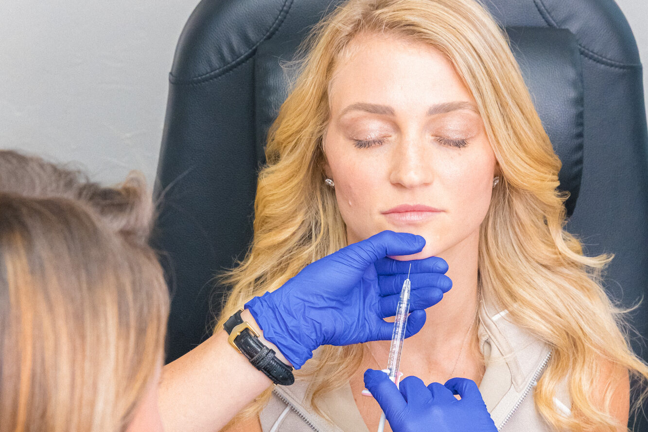 A nurse injector strategically places a patient's dermal fillers in Muncie.
